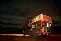 Ford F150 with popup camper, camping at night, Dubois Badlands near Dubois, Wyoming, USA, April 2012.