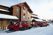 Snowlodge with snowcoaches parked outside.  Upper Geyser Basin, Yellowstone National Park, Wyoming, USA, January.