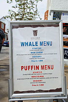 Menu outside a restaurant advertising Whale and Puffin meat, Reykjavik, Iceland, July 2012.