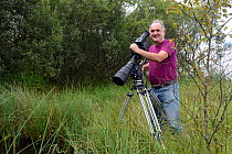 Photographer Sinclair Stammers filming pond life, Cors Caron, also known as Tregaron Bog, Ceredigion, Wales, August 2013.