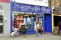 Women leaving Cancer Research UK charity shop, Upper Street, London Borough of Islington, London, England, UK, March 2009