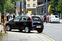 Car parked on pavement Holloway London Borough of Islington, England, UK, July 2009.