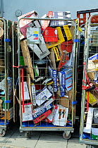 Cardboard boxes in wire trolley outside supermarket waiting to be collected for recycling, Highbury, London Borough of Islington, England, UK, August 2013.