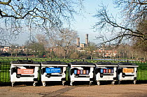 Black and white cow recycling bins in Clissold Park with The Castle Climbing Centre in background, Stoke Newington, London Borough of Hackney, England, UK, January 2013.