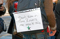 Card on girls back saying - &#39;Don&#39;t blow it - Good Planets are Hard to Find&#39; at Climate Change march, Central London, England, UK, December 2008.