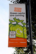 Banner saying &#39;Green sacks are coming&#39; hanging from lamppost to encourage local residents to recycle their waste. The London Borough of Hackneys operates a mixed or commingled system of recycl...