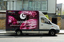 Ocado delivery van with &#39;Quality groceries that won&#39;t cost the earth&#39; - printed on the side, outside flats, Holloway, London Borough of Islington, England, UK, April.