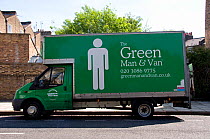 The Green Man and Van printed on side of green coloured van with Carbon Neutral on the door, London Borough of Hackney, England, UK, May 2013.