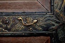 Bronze carving of a Phoenix on one of the doors within the Forbidden City, Beijing, China, September 2008.