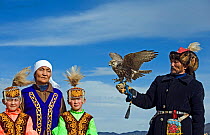 Kazakh hunter with Saker Falcon (Falco cherrug) at Eagle hunters festival near Ulgii, western Mongolia, October 2008.