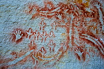 Aboriginal rock art at the 'Art Gallery' in Carnarvon Gorge, Queensland. Stencil art measured to be 2000 years old shows depictions of hands boomerangs Rock Wallaby bones and Emu feet.