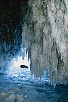 Ice formations in cave - with car outside, Lake Baikal, Siberia, Russia, March.