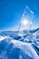 Sun shining through a clear pane of ice on sunny day, Lake Baikal, Siberia, Russia, March.