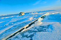 Van on frozen Lake Baikal with cracked ice, Lake Baikal, Siberia, Russia, March.