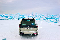 Car on thick Lake Baikal ice, Lake Baikal, Siberia, Russia, March. Property released.