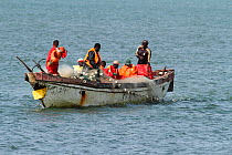 Fishermen in boat, Tanji Beach, Gambia, West Africa.