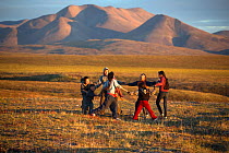 Chukchi children playing outside in evening sunshine at a Chukchi reindeer herder's summer camp. Iultinsky District, Chukotka, Siberia, Russia, August 2013.