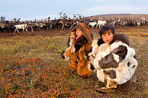 Nadia Takui takes Rima Votgyrgina, age 18 months, to watch the reindeer during the Chukchi 'Festival of the Young Reindeer' out on the tundra. Iultinsky District, Chukotka, Siberia, Russia, August 201...