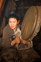 In the evening of the first day of the Chukchi 'Festival of the Young Reindeer', Tamara plays her family's sacred drum in their Yaranga (tent). The Chukchi believe that the sounds of the drum calms th...
