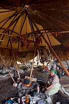 Lidiya, a Chukchi woman, inside her Yaranga (tent) near Amguema. Iultinsky District, Chukotka, Siberia, Russia, August 2013.