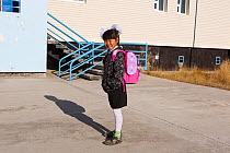 Nadia Takui, girl aged 9 years from a Chukchi reindeer herding family, dressed up for the first day of the new school year  at Amguema. Iultinsky District, Chukotka, Siberia, Russia, September 2013.