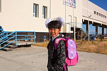 Nadia Takui, girl aged 9 years from a Chukchi reindeer herding family, dressed up for the first day of the new school year  at Amguema. Iultinsky District, Chukotka, Siberia, Russia, September 2013.