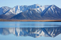 Mountains of the Chukotskiy Range reflected in a mountain lake. Amguema, Iultinsky District, Chukotka, Siberia, Russia, September 2013.