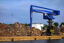 Dock crane and heap of scrap metal for recycling, Port of Ghent, Belgium, July 2013.