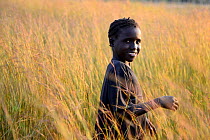 Girl at sunset on the grain fields. Eticoga village. Orango Island, Guinea Bissau, December 2013.