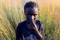 Girl at sunset on the grain fields. Eticoga village. Orango Island, Guinea Bissau, December 2013.