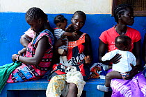 Children with their mothers at infant medical centre to be vaccinated against polio, Canogo Island, Guinea-Bissau, December 2013.