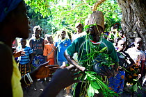 Dancing and music, with man in traditional garments made of palm leaves, at a wedding in the village of Ambeduco. Orango Island, Guinea-Bissau, December 2013.