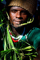 Man wearing traditional clothing made of palm leaves at wedding in Ambeduco village, Orango Island, Guinea-Bissau, December 2013.
