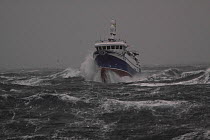 Fishing vessel &#39;Harvester&#39; powering through rough seas while operating in the North Sea,  December 2013. All non-editorial uses must be cleared individually.