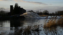 Flood water being pumped from Lower Salt Moor into the River Parrett near Burrowbridge, Somerset Levels, England, UK, February 2014.