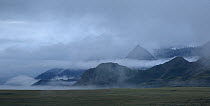 Altai steppe Mountains with smoke at the merge of rivers Katun and Chuya, Russia. August 2013.