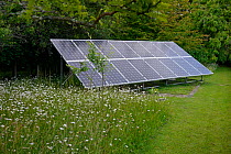 Photo voltaic solar panels set in garden, Sussex, England, UK, June.