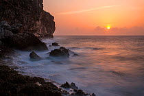Sun rising over cliffs of Cayman Brac, Cayman Islands.