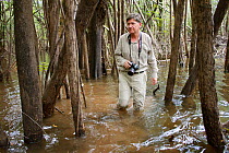 Photographer Michel Roggo in the flooded forest of the Amazon, Rio Negro tributary, Amazon, Brazil, February 2011. Taken for the Freshwater Project.