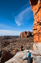 View from Wolfberg Cracks and Arch with man sitting on rock, Cederberg Conservancy, South Africa, August 2011.