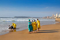 Traditional healers performing a baptism on Durban beach, KwaZulu-Natal, South Africa, August 2009.