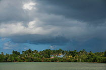 Eastern tip of Cuba near Baracoa seen from the sea with dark clouds overhead, Guantanamo Province, Cuba, November 2011.