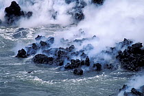 Thick steam billows rising where lava flow enters the sea.