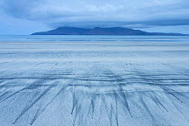 Patterns on beach and view to sea and the Isle of Rum, seen from Eigg, Scotland, May 2013.