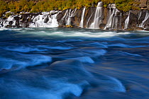 Hraunfossar waterfalls flowing into the Hvita river in autumn, Iceland, September 2013.