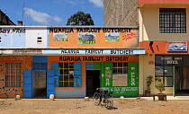 Small shops including a butchers with a bicycle outside, Kenya, October 2013.