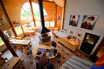 Two people on their laptops, Restaurant Skaidi, Nikkaluokta Sarri Lodge, Nikkaluokta, Greater Laponia Rewilding Area, Lapland, Norrbotten, Sweden, June 2013.