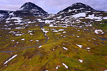 Aerial view of mountains with melting snow, the source of the Vietasatno River, Stora Sjofallet National Park, Greater Laponia Rewilding Area, Lapland, Norrbotten, Sweden, June 2013.