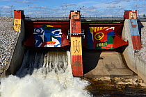 Colourful paintings on dam, Stora Sjofallet hydro electric power station, Greater Laponia Rewilding Area, Lapland, Norrbotten, Sweden, June 2013.