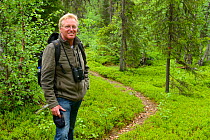 Frans Schepers, Managing Director of Rewilding Europe,  on King's Trail hiking trail with binoculars, Padjelanta National Park, Kvikkjokk, Greater Laponia Rewilding Area, Lapland, Norrbotten, Sweden,...